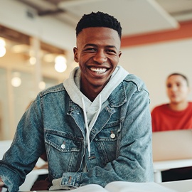Portrait of a group of young children standing in a line in the hallway of a school